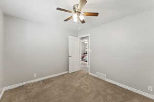 Unfurnished room featuring carpet flooring and ceiling fan