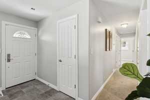 Foyer entrance featuring baseboards