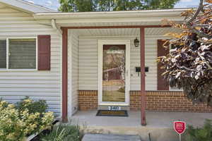 Property entrance featuring brick siding
