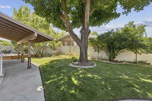 Fenced backyard with a patio