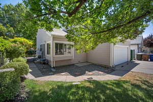 View of side of home with driveway, a garage, and a new shingled roof.