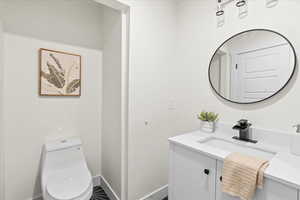 Bathroom featuring vanity and toilet