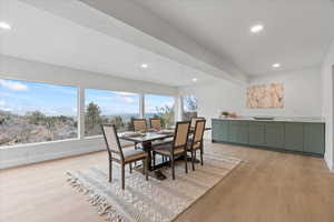 Dining area with recessed lighting and light wood finished floors
