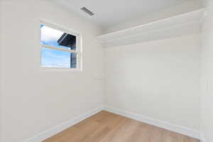 Unfurnished room with baseboards and light wood-type flooring