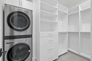 Laundry area featuring stacked washer / drying machine