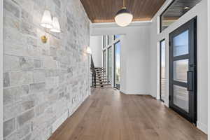 Entryway featuring wood finished floors, stairway, and wood ceiling