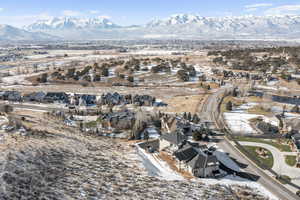 Snowy aerial view with a residential view and a mountain view
