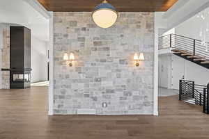 Corridor with stairs, wood finished floors, wooden ceiling, and recessed lighting