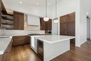 Kitchen with open shelves, dark wood-style flooring, decorative backsplash, a kitchen island, and high vaulted ceiling