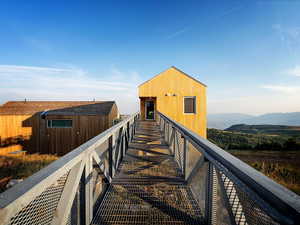 Rear view of property featuring a mountain view and an outbuilding