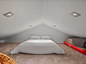 Carpeted bedroom with vaulted ceiling