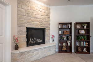 Master Suite with floor to ceiling gas fireplace with hearth, carpeted with ornamental molding, 3-tone paint
