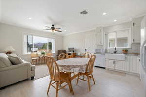 ADU Dining space with ornamental molding, ceiling fan, and recessed lighting, full kitchen with convection oven, microwave, farm sink, dishwasher, tile / carpet flooring.