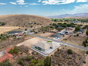 Aerial view of residential area featuring a desert landscape and a mountain backdrop