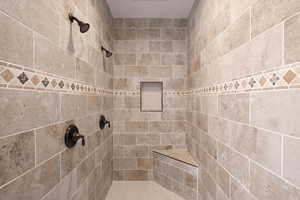 Master suite full shower featuring beautiful tile, dual faucets and seat.