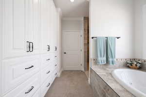 Full master suite bath featuring a jetted garden, ornamental molding and lots of storage with soft-close cabinetry.