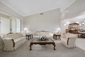 Formal living / dining rooms featuring crown molding, carpet & tile flooring, and high vaulted ceiling, three-tone paint, vaulted ceilings and recessed lighting