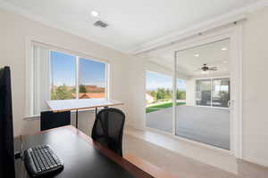 Spacious Home Office attached to master suite with crown molding, recessed lighting, light colored carpet, and a ceiling fan plus sliding glass doors to the rear covered patio.