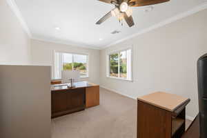 Home Office attached to master suite featuring ornamental molding, light carpet, ceiling fan, and recessed lighting