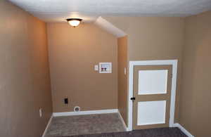Washroom featuring hookup for a washing machine and a textured ceiling