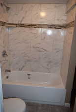 Full bath featuring  shower combination and tile patterned floors