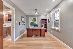 Office space with light wood-style floors, ceiling fan, and recessed lighting