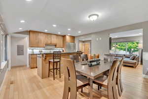 Dining room featuring light wood-type flooring and recessed lighting
