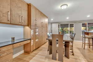 Dining space featuring light wood-type flooring, recessed lighting, and built in desk