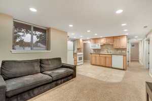 Living room featuring light carpet, recessed lighting, and light tile patterned flooring