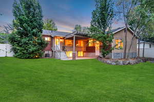 Back of house with stucco siding and a patio area