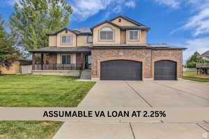View of front of home with covered porch, roof mounted solar panels, stucco siding, and concrete driveway