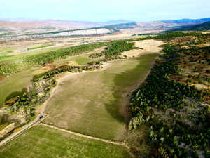 Drone / aerial view of mountains and a local golf course