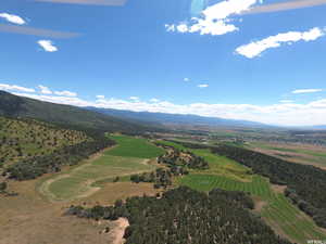 Bird's eye view of mountains and a golf club
