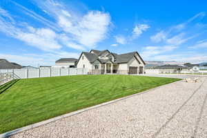 Modern farmhouse with stone siding, a mountain view, concrete driveway, and a garage