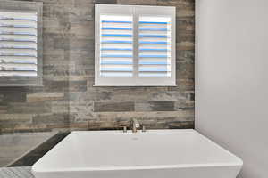 Full bathroom with a freestanding bath and healthy amount of natural light