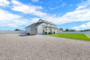 Back of property with a fenced backyard and a patio area
