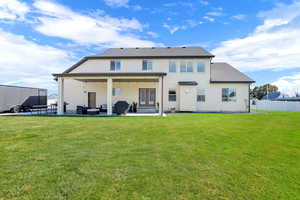 Rear view of property with a patio
