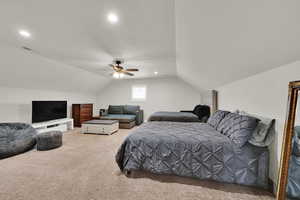 Bedroom with lofted ceiling, light carpet, a ceiling fan, and recessed lighting