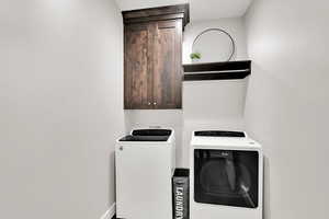 Washroom with cabinet space and washer and dryer