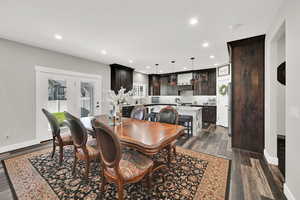 Dining area featuring dark wood finished floors, recessed lighting, and french doors