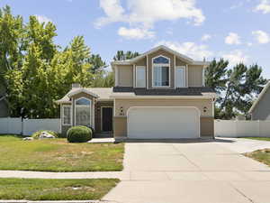 View of front facade featuring a garage, concrete driveway, and brick siding, RV Parking