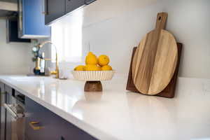 Kitchen view of blue cabinets and light countertops