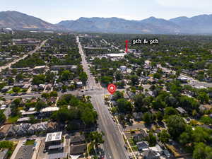 Aerial view of property and surrounding area featuring mountains