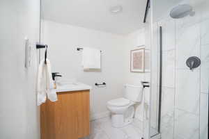 Bathroom with vanity, a textured ceiling, and a shower stall