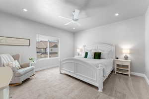 Bedroom with light colored carpet, recessed lighting, a ceiling fan, and a textured ceiling