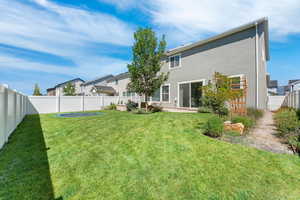 Rear view of property featuring a fenced backyard and stucco siding