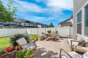 Fenced backyard with outdoor dining space, a residential view, and a patio
