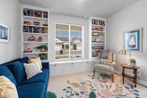 Sitting room with carpet floors and built in features