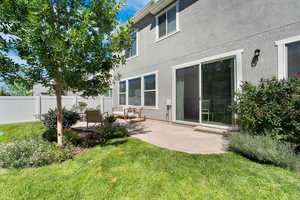 Rear view of house featuring a patio and stucco siding