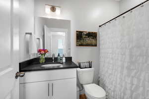 Bathroom with vanity and curtained shower